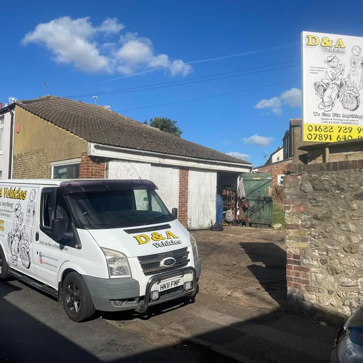 The D&A Vehicles van parked in front of the open workshop, with the painted sign above the wall